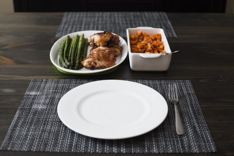 A person practicing caloric restriction vs intermittent fasting, with a clock and a measured meal on a table representing both longevity approaches