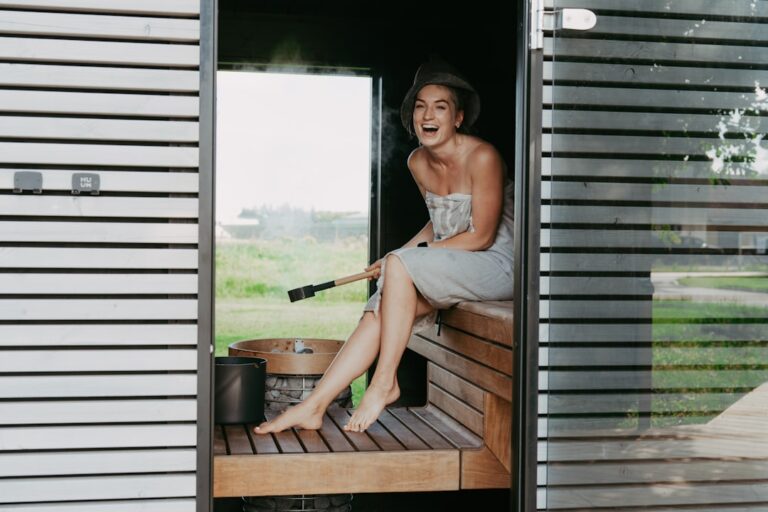 Person relaxing in a traditional Finnish sauna with wooden benches and steam, representing sauna and longevity research