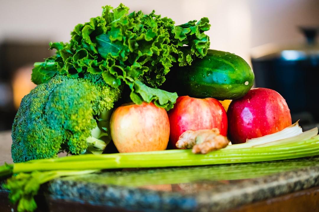 A spread of longevity diet foods including vegetables, legumes, fish, olive oil, and whole grains on a wooden table