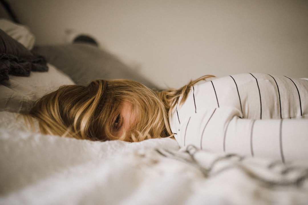 Person sleeping deeply in a dark room, illustrating sleep and longevity statistics