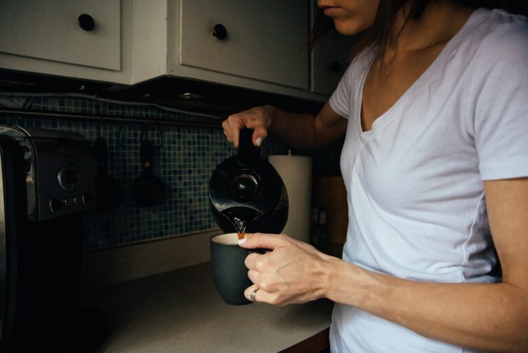 A person pouring a fresh cup of coffee in morning light, representing the optimal coffee and longevity dose