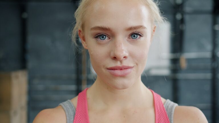 A woman over 50 lifting weights in a gym — muscle loss after menopause guide