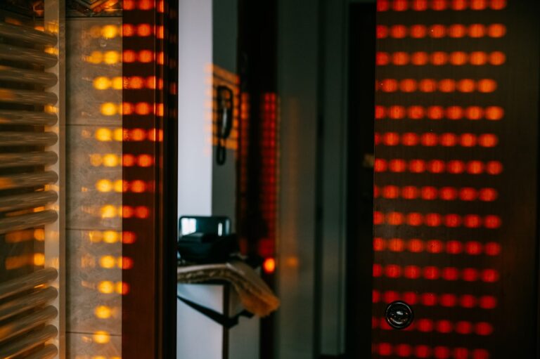 Person using a red light therapy panel for anti-aging and longevity benefits