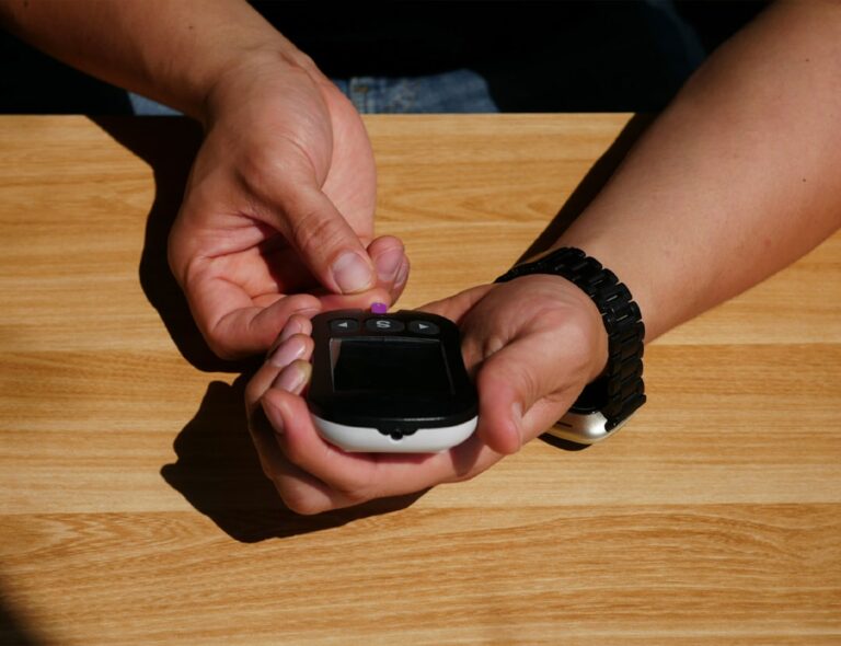 A healthy adult in their 50s having their blood pressure measured, illustrating age-specific blood pressure targets for longevity