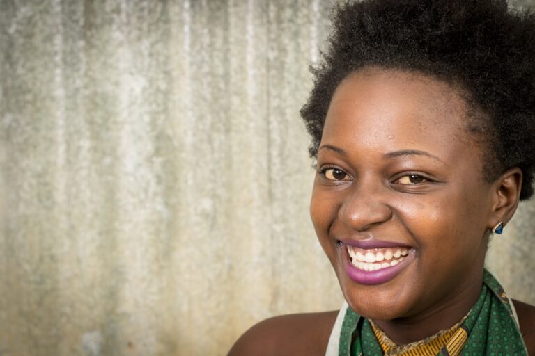 A healthy woman smiling, representing the connection between dental health and longevity