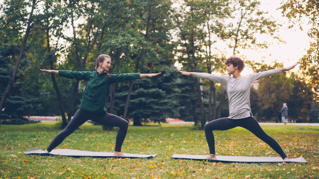A woman practicing single-leg balance yoga pose outdoors, illustrating mobility and balance longevity training