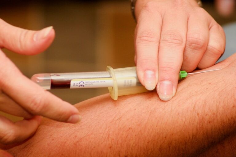 Doctor reviewing ApoB vs LDL cholesterol blood test results in a modern lab setting