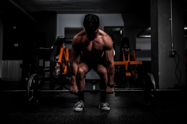 Man over 50 doing strength training in a gym, illustrating creatine after 50 dosing and muscle health