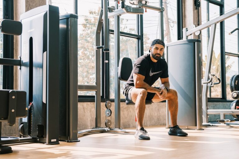 Man training grip strength with weights at a gym, illustrating grip strength longevity targets by age