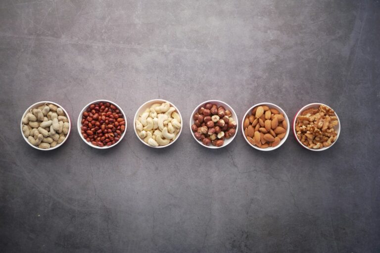 Magnesium-rich foods including nuts, seeds, and leafy greens arranged on a wooden surface — magnesium dosage by age reference