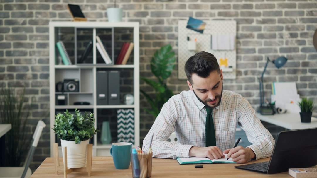 Person sitting at a desk for long hours, illustrating the health risks of sitting time and longevity research