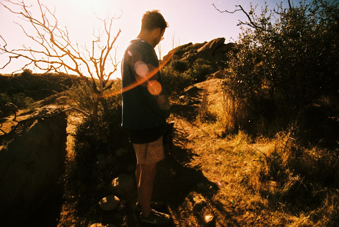 Man running on an outdoor trail to improve VO2 max, demonstrating home-based cardiorespiratory fitness testing