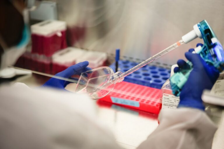 Researcher examining blood sample tubes in a modern laboratory studying the GDF11 longevity protein