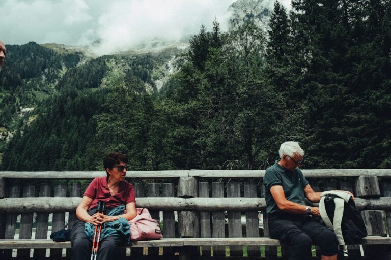 Two healthy older adults walking outdoors, illustrating the longevity benefits of hearing health and active aging