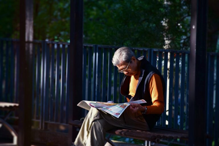 An older adult reading and thinking, representing the use of magnesium threonate for brain aging and cognitive health