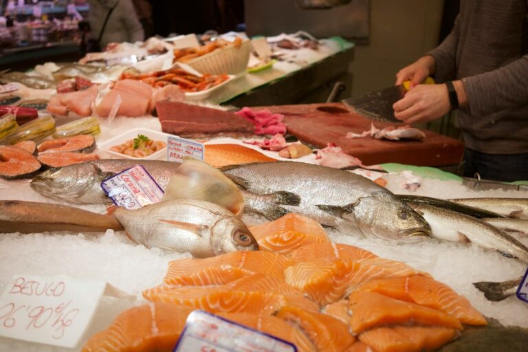 Fresh salmon fillet and omega-3 rich foods on a wooden board, representing optimal omega-3 index nutrition for longevity