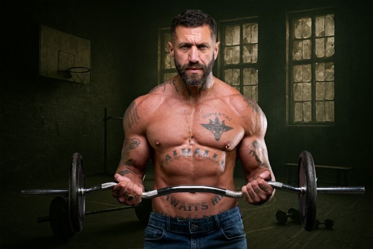 Fit man over 50 doing strength training in gym, representing urolithin A vs creatine for aging muscle