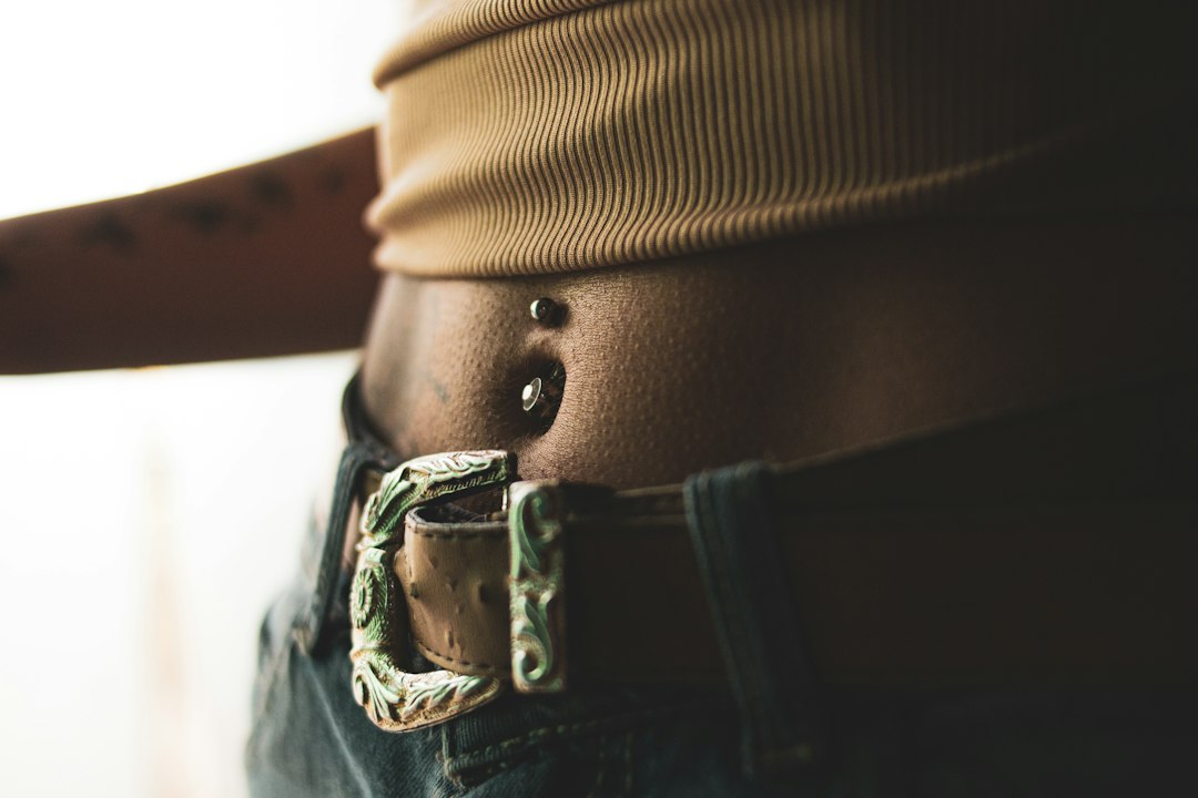 Person measuring waist circumference to calculate waist-to-height ratio for longevity